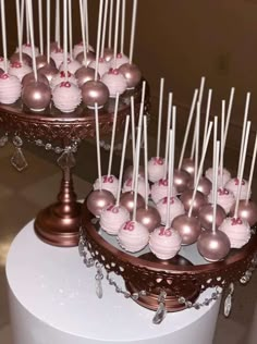 two tiered trays with cake pops on them