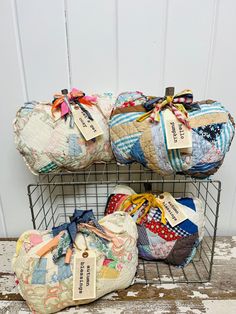 three bags are stacked on top of each other in front of a white wooden wall