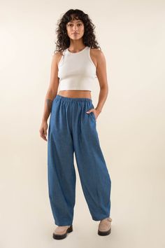 A longer and wider version of our Denim Lantern Pant - Denim wide leg lantern pant with elastic waistband, side pocket, and art detail at hem. High-waisted fit Side pockets Locally sourced Washed Lightweight Denim Cut and sewn ethically, in-house at our factory in DTLA Fit Model is 5'7" and wearing size S View full Size Chart Content & Care 100% Cotton Machine wash cold. Tumble dry low. Lightweight Denim Pants, Pajamas Aesthetic, Denim Wide Leg, Fleece Dress, Cool Stuff To Buy, Outerwear Vest, Long Sleeve Tee Shirts, Wide Leg Denim, New Tops