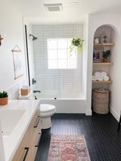 a bathroom with black and white tile flooring