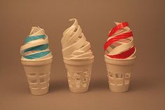 three different types of ice cream in plastic cups with ribbons on them, one is white and the other is blue