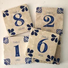 four blue and white tiles with numbers on them