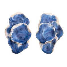 two blue and white ceramic flowers on a white background