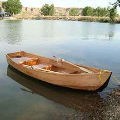 a small wooden boat sitting in the water