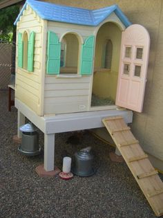 there is a play house built into the side of a building with steps leading up to it