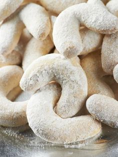 a pile of sugar coated donuts sitting on top of a table