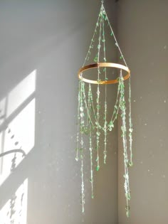 a wind chime hanging in the corner of a room