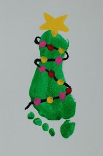 a child's drawing of a green christmas tree with stars on top and feet