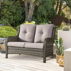 a blue couch sitting on top of a wooden deck