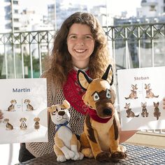 a woman holding up two stuffed animals on top of a table next to each other