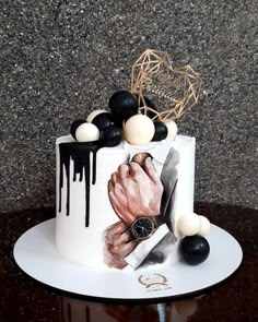 a white cake with black and white decorations