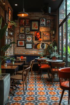 the interior of a restaurant with tables, chairs and pictures on the wall behind them