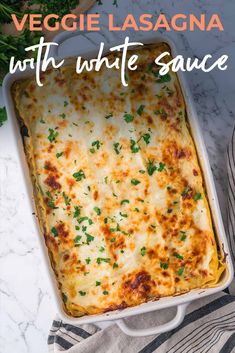 a casserole dish with cheese and parsley in it on a marble counter top