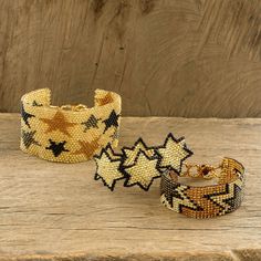 The Artisans of Panabaj in Guatemala create this fun and funky set of three friendship bracelets each with a star motif in gold and black tones. The set includes a wide wristband spangled with stars in deep gold black and bronze; a deep gold wristband with large bronze stars; and a bracelet formed of multiple stars that have been joined together. Black Star Bracelet, Hand-strung Gold Bohemian Friendship Bracelets, Bohemian Star-shaped Beaded Bracelet, Adjustable Yellow Gold Star Bracelet, Adjustable Star-shaped Celestial Bracelets, Buy Bead, Black Set, Black Star, Bracelet Set