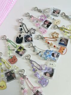 a collection of key chains with pictures and charms attached to them