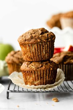 three muffins sitting on top of a cooling rack