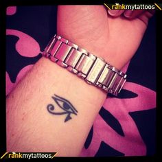 an egyptian eye tattoo on the wrist