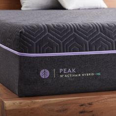 the peak h2 activir hybrid hybrid mattress is on top of a wooden platform