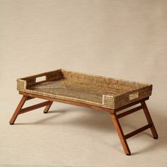 a wicker tray sitting on top of a wooden stand