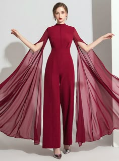 Jumpsuits have a certain simplicity that makes them different from the rest. Their simplicity is complemented with the beauty of the design and makes them simply irresistible. This burgundy jumpsuit has a high neck neckline that is paired with long floor length sleeves having high slits. The tulle fabric cascades from the sleeves and creates an artistic look. The dress has linear details that outline the curvatures of your beautiful body. Full length trousers bottoms create a perfect look for this jumpsuit. A zip at the back of this sheath dress completes its artful look and gives you a beautiful unmatched look. Ankle Length Evening Dress, Classy Evening Dress, Evening Dress Patterns, Backless Evening Dress, Girls Formal Dresses, Jumpsuit Elegant, Sleeves Designs For Dresses, Stylish Party Dresses, Stylish Dress Designs