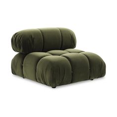 the reclining chair is made out of green velvet and has four pillows on it