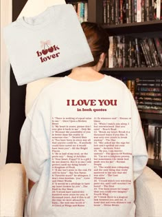 a woman sitting in a chair with her back turned to the camera and has a t - shirt over her head that says i love you