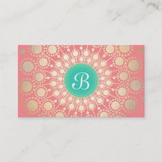 a pink and gold business card with the letter b on it's front side