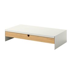 a white and wood coffee table with two drawers on each side, in front of a white background