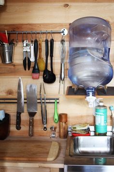 a kitchen sink filled with lots of cooking utensils