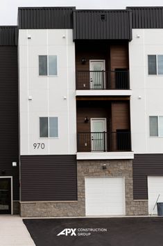 an apartment building with two garages on the second floor