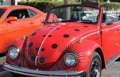 an orange car with black polka dots on it