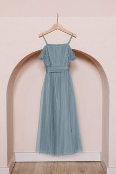 a blue dress hanging on a wooden hanger