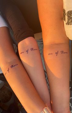 two girls with matching tattoos on their arms that say, one of them is mine