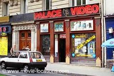 a car is parked in front of a video store