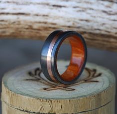 a wooden ring sitting on top of a piece of wood