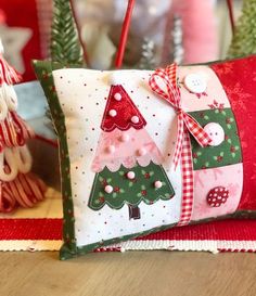 two decorative christmas trees are sitting on the table