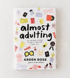 the book almost adulting by arden rose is sitting on top of a white surface