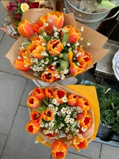 two bouquets of flowers sitting on top of each other