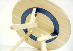 a clock made out of wood and blue straps