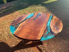 a wooden table sitting on top of a dirt field