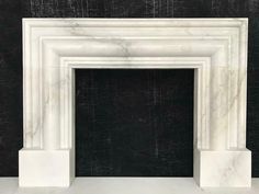 a white marble fireplace surround with black background