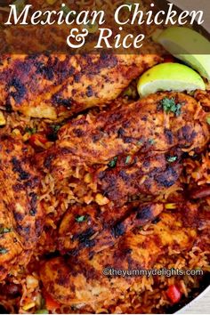 mexican chicken and rice in a white bowl with lime wedges on the side for garnish