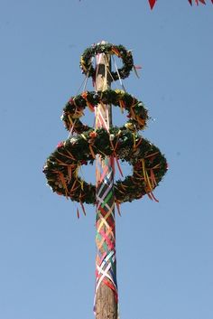 a pole decorated with wreaths and ribbons