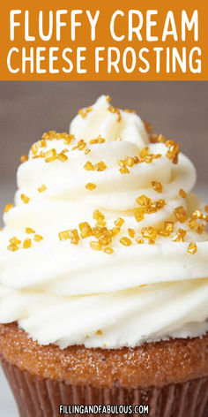 a cupcake with white frosting and gold sprinkles on top that says fluffy cream cheese frosting