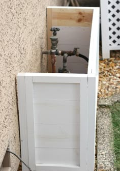 an open door is shown in front of a wall with pipes coming out of it