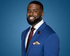 a man in a blue suit and red tie