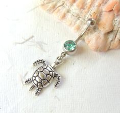 14g belly ring with cute dangle sea turtle charm. You choose barbell gem color. Belly ring measures 1 7/8 inches long total length. Barbell is 14g surgical steel with a 10mm wearable bar length. Top ball measures 5mm, bottom ball measure 8mm. For Belly Button Rings: https://www.etsy.com/shop/AllAboutClass?section_id=18474235&ref=shopsection_leftnav_1 All body jewelry sales are final!! AllAboutClass DOES NOT accept any returns on body jewelry for sanitary reasons. This is a standard policy in the Turtle Belly Button Piercing, Cute Belly Rings, Bellybutton Piercings, Belly Button Piercing Jewelry, Belly Piercing Jewelry, Button Piercing, Belly Button Jewelry, Dangle Belly Rings, Belly Jewelry