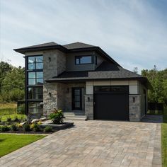 a large house with two garages on the front and one car parked in the driveway