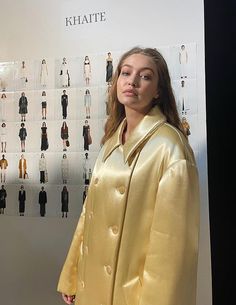 a woman standing in front of a display of clothes