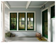 the front porch is painted white and has green trim